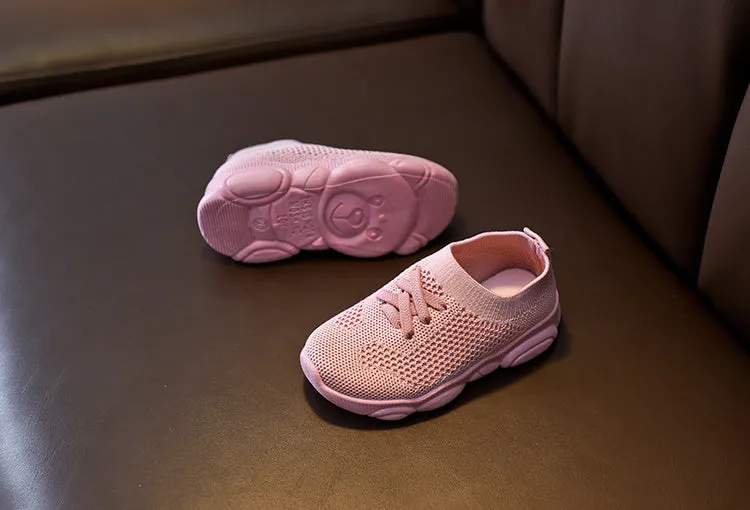 Children's white fabric lazy shoe with a non-slip rubber sole, shown on a foot.