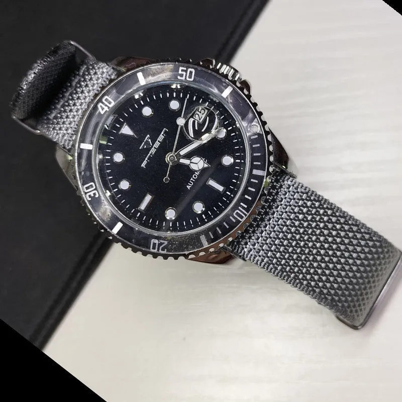 Nylon integrated watch strap in army green colour showing textile weave and buckle.