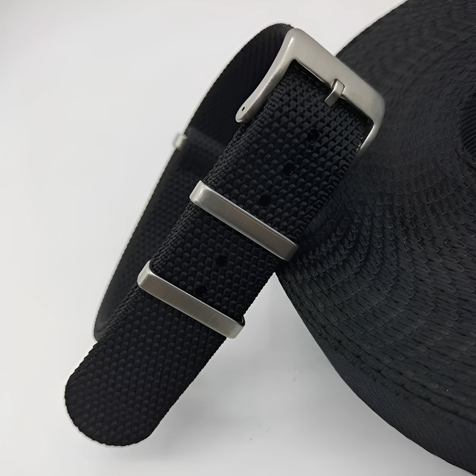 Nylon integrated watch strap in army green colour showing textile weave and buckle.