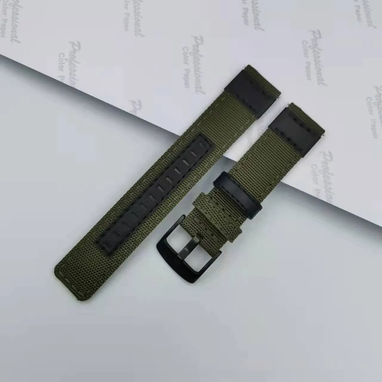 Canvas Oxford cloth watch strap in Army Green, showing textured fabric and metal buckle.
