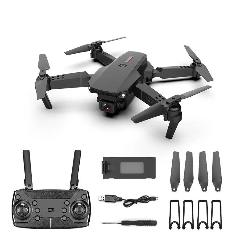 Grey foldable 4K dual camera drone with remote controller on a table.