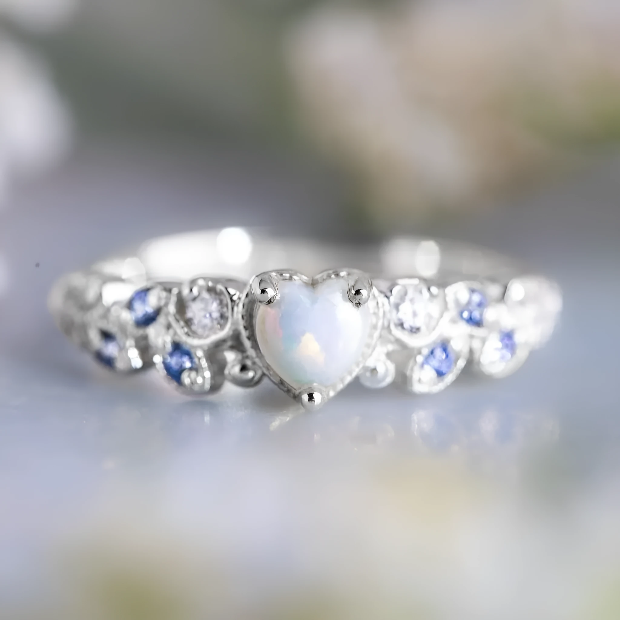 White alloy women's ring with a heart shape and floral opal ocean design details.