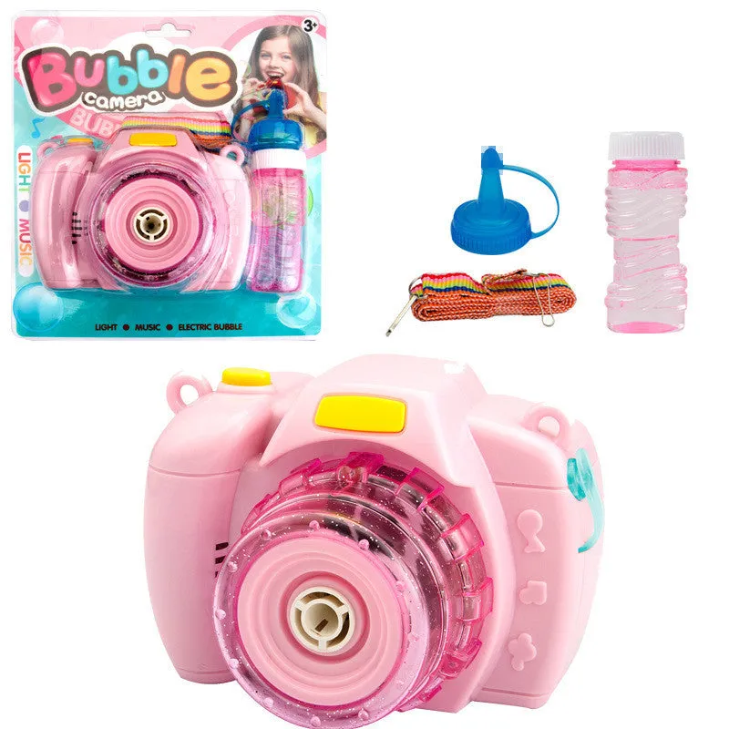 Yellow automatic camera-shaped bubble machine for children on a green lawn, producing soap bubbles.