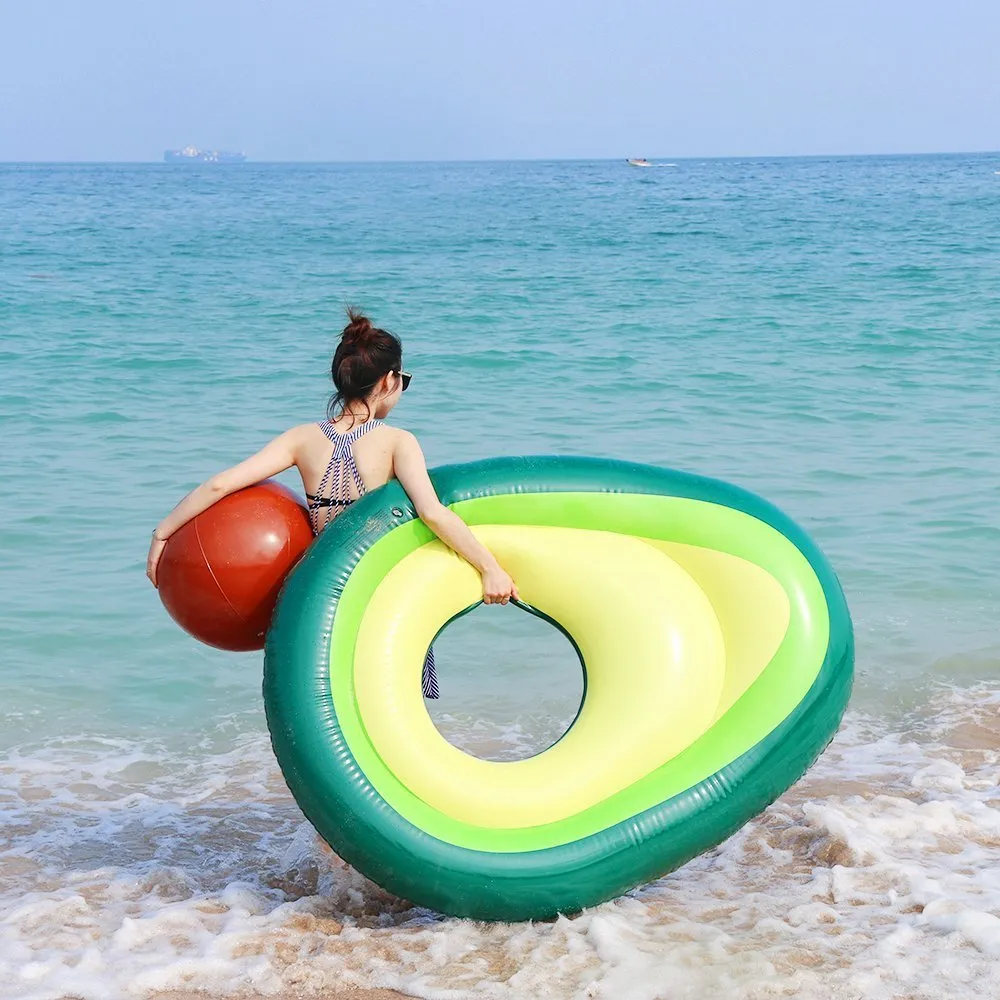 Green giant avocado-shaped inflatable pool float on water