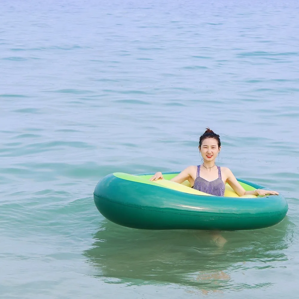 Green giant avocado-shaped inflatable pool float on water