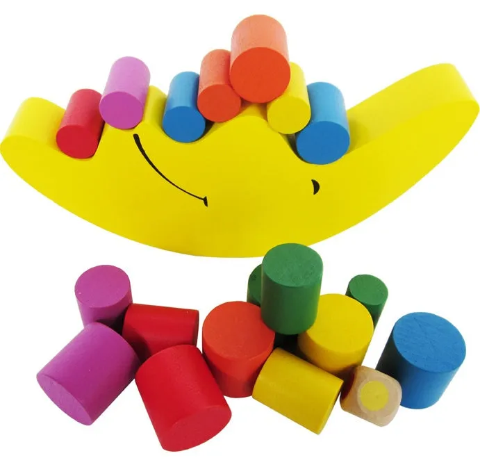 Yellow and blue moon-themed wooden balance game toy for toddlers on a white background.