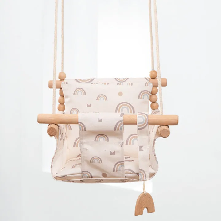 Cotton canvas baby swing chair with wooden seat and cushion hanging indoors