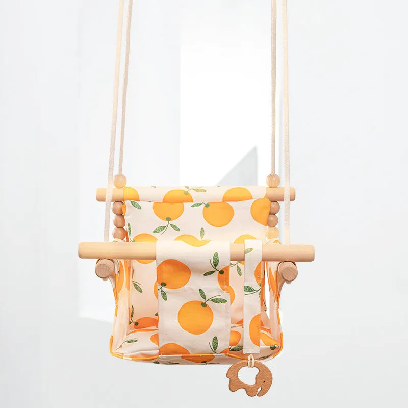 Cotton canvas baby swing chair with wooden seat and cushion hanging indoors