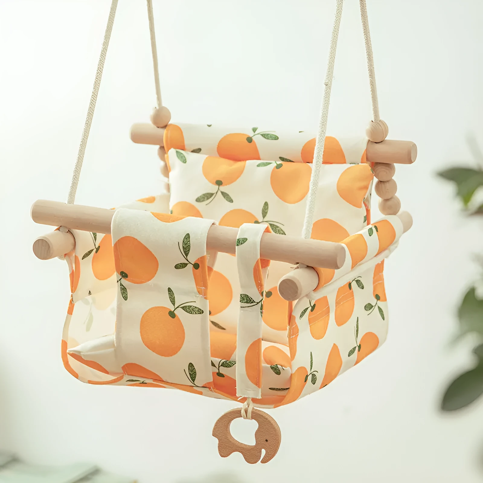 Cotton canvas baby swing chair with wooden seat and cushion hanging indoors