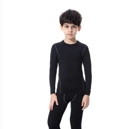 Children's sportswear set showing black and green t-shirts, shorts, and trousers for football and active play.