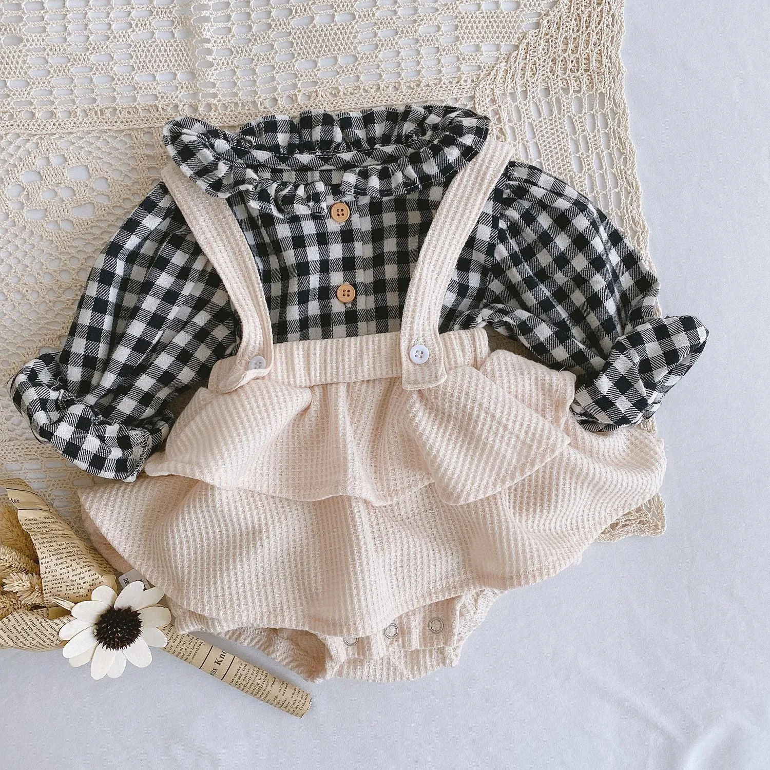 Baby girl in a pleated lotus leaf style cotton romper, triangle climb suit design for 0-2 year olds.