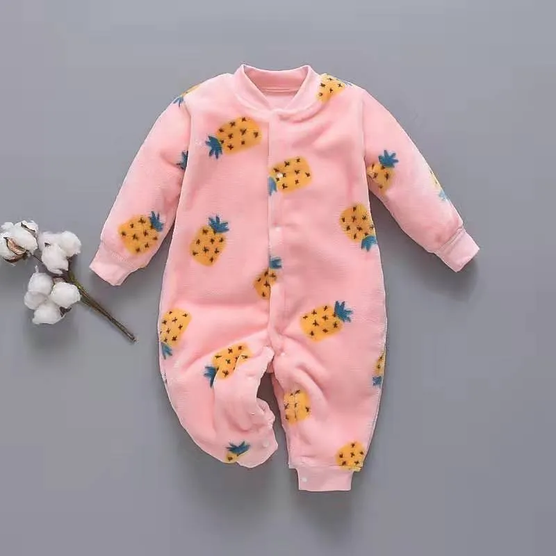 Baby wearing a long-sleeved flannel romper in a pink bunny head print, showcasing the 100% cotton fabric.