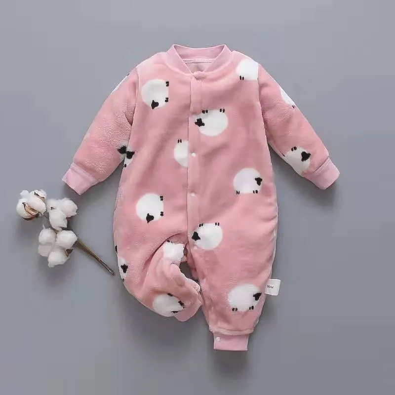 Baby wearing a long-sleeved flannel romper in a pink bunny head print, showcasing the 100% cotton fabric.