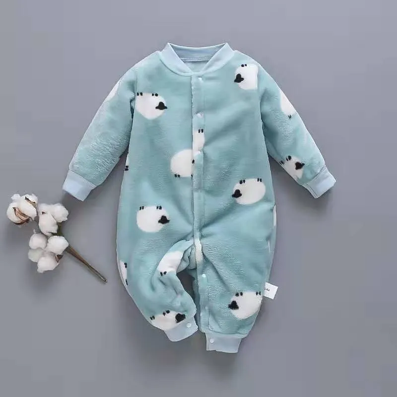 Baby wearing a long-sleeved flannel romper in a pink bunny head print, showcasing the 100% cotton fabric.
