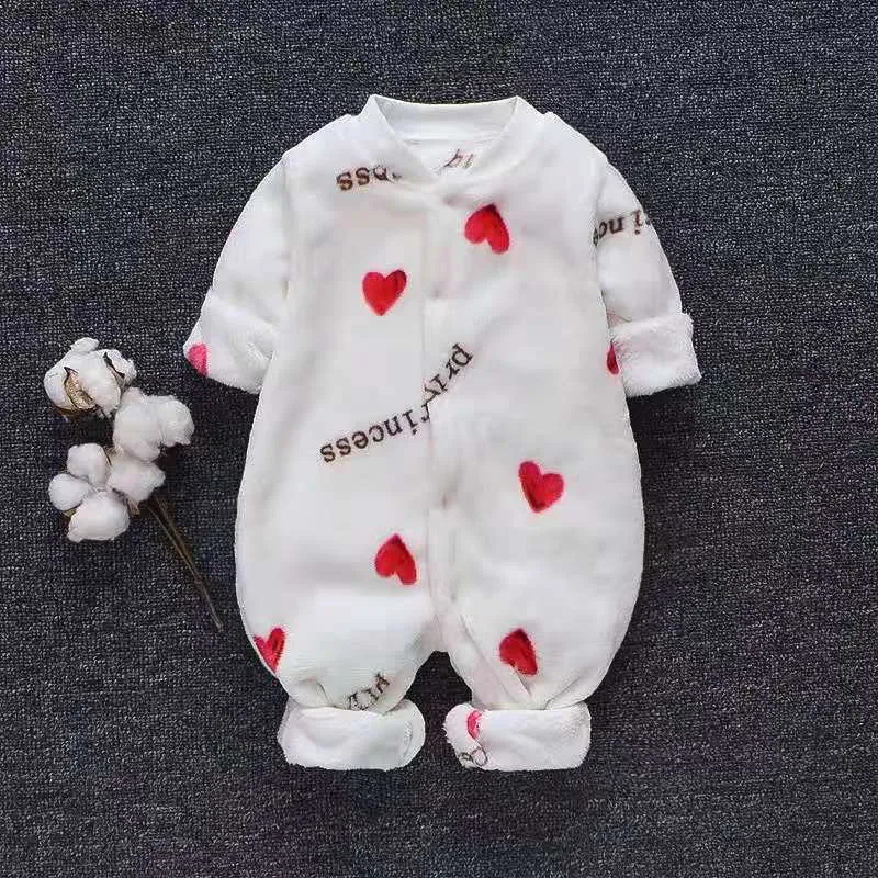 Baby wearing a long-sleeved flannel romper in a pink bunny head print, showcasing the 100% cotton fabric.