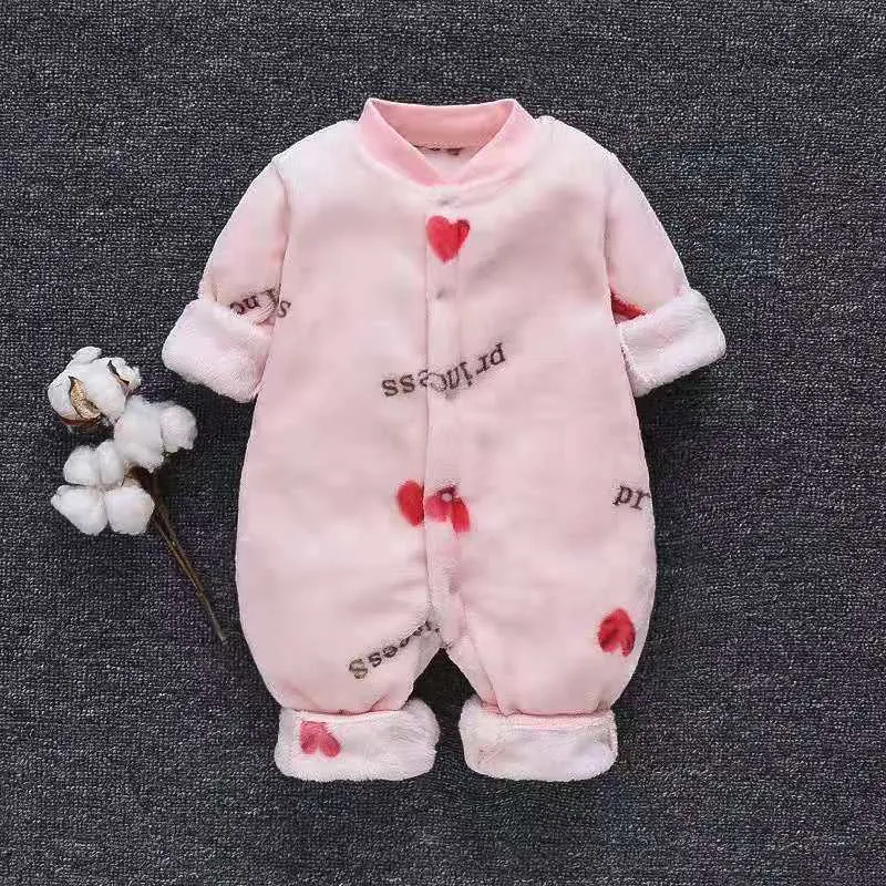Baby wearing a long-sleeved flannel romper in a pink bunny head print, showcasing the 100% cotton fabric.