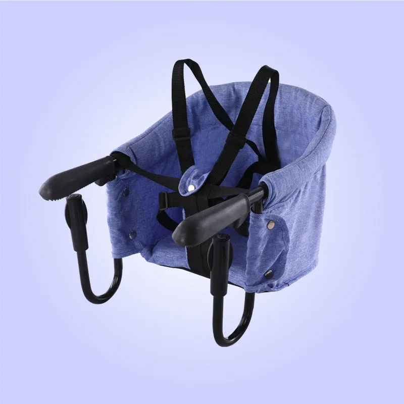 Portable baby dining seat with safety belt in blue, grey or red colours folded to show compact 42x36x7cm size