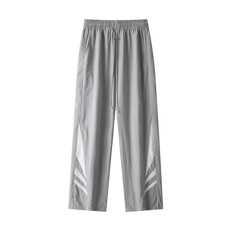 Men's straight-leg grey cotton blend sports trousers with an elasticated waistband laid flat.