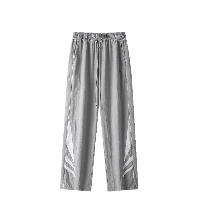Men's straight-leg grey cotton blend sports trousers with an elasticated waistband laid flat.