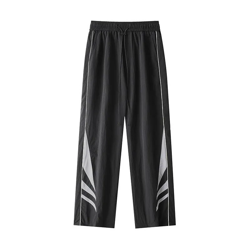 Men's straight-leg grey cotton blend sports trousers with an elasticated waistband laid flat.