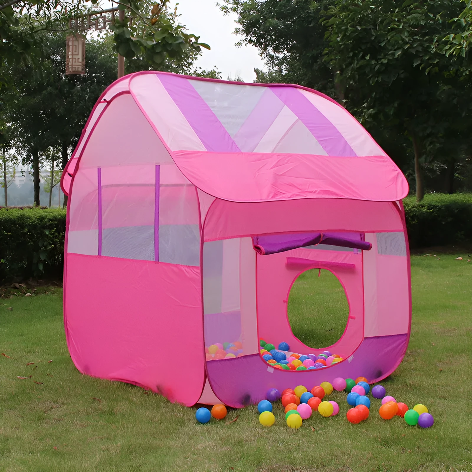 Large blue outdoor children's play tent in a garden with roll-up curtain.