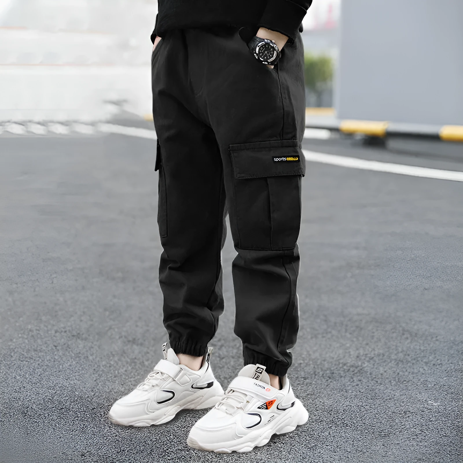 Boys' casual cotton trousers in army green, shown laid flat with size label visible.