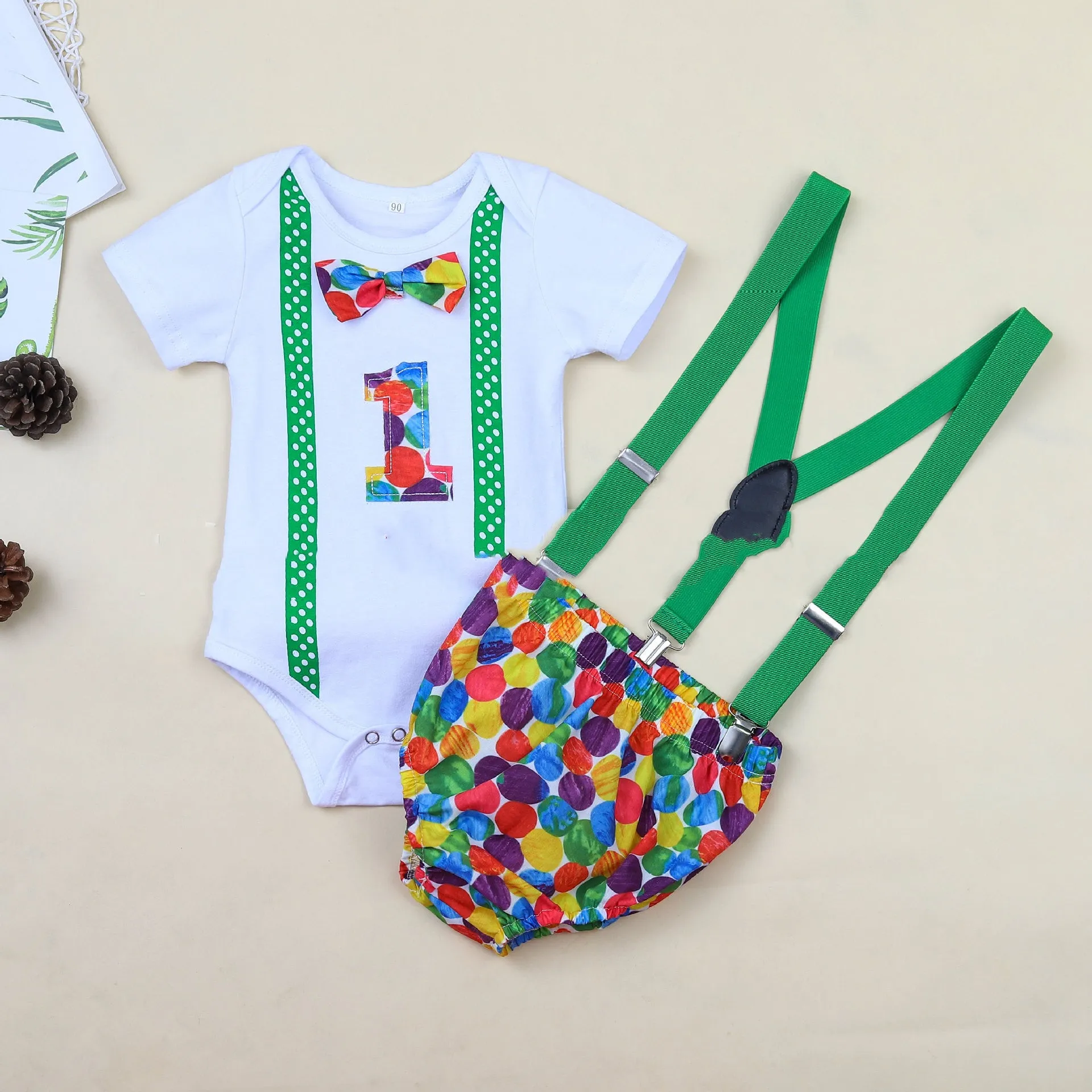 Cotton baby romper set with dinosaur print in blue or green, shorts length with ruffles and straps
