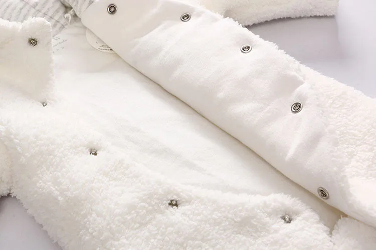 Baby wearing a brown cotton padded winter jumpsuit with long sleeves