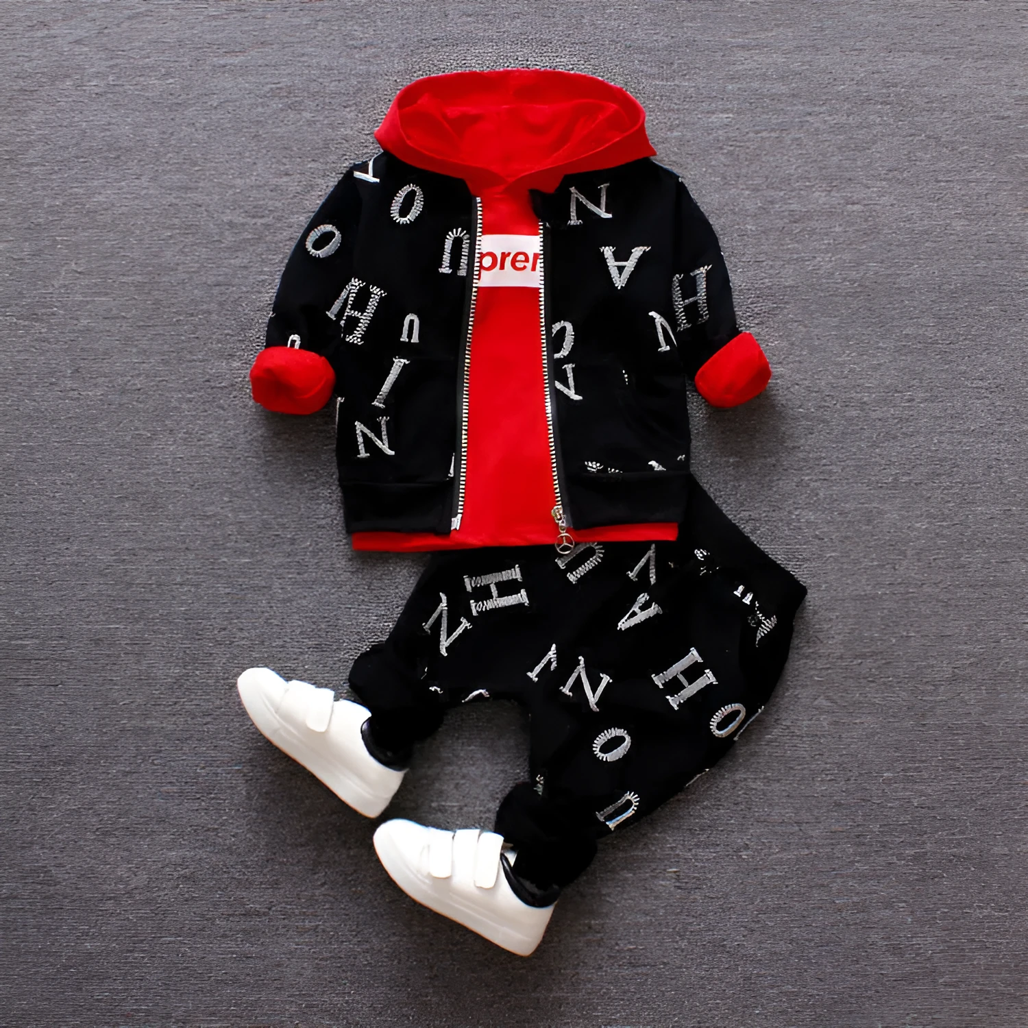 Red and white children's long sleeve two-piece clothing set made from polyester and vinylon fabric.