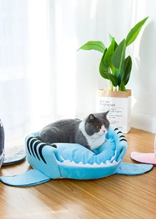 Grey shark-shaped pet bed for a small dog, showing its enclosed den design.