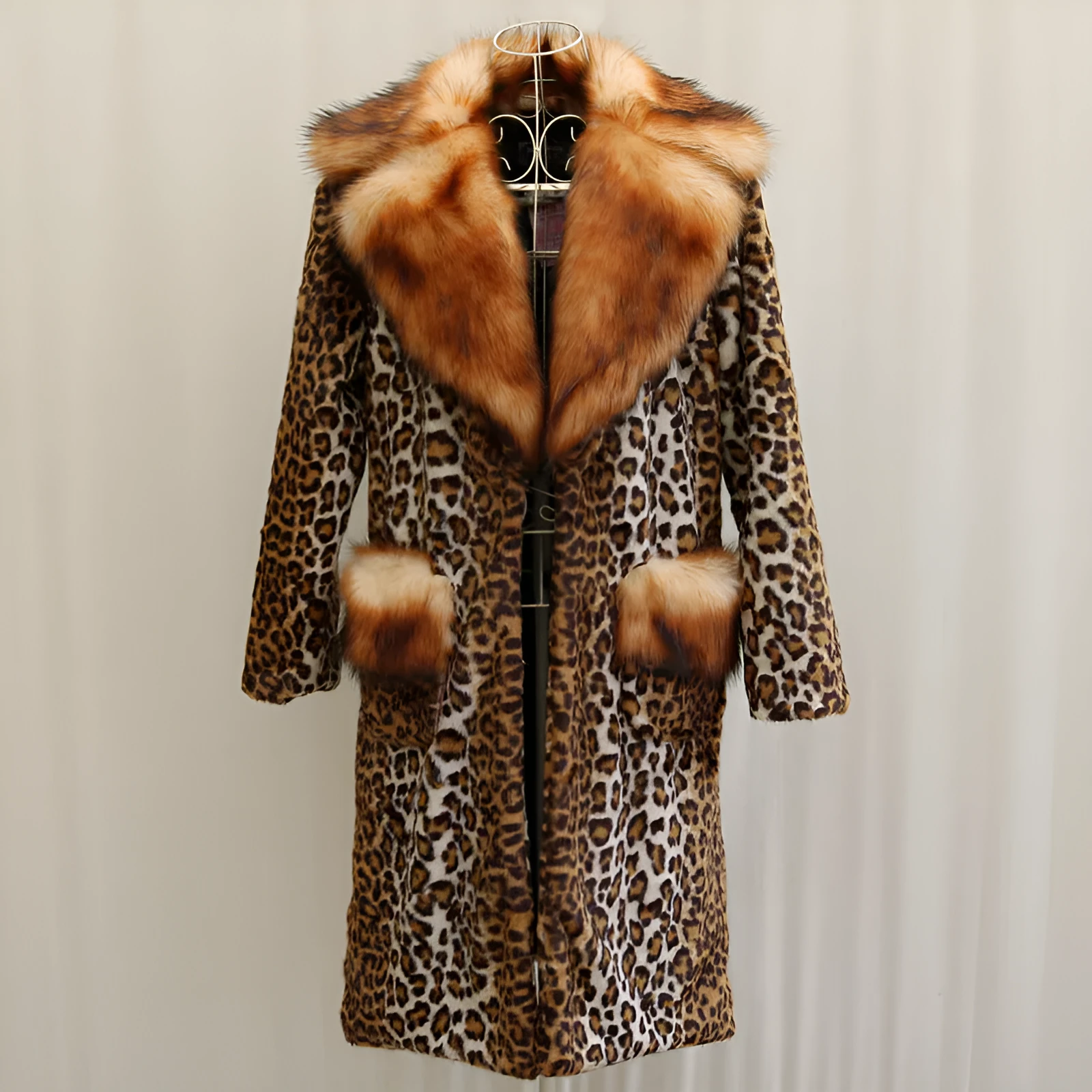 Women's long leopard print artificial fur jacket with regular sleeves on a hanger.