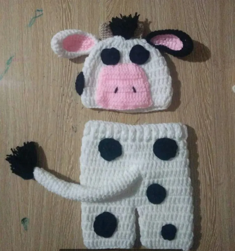 Hand-knitted white newborn cow suit with matching hat and pants for 0-3 month infants