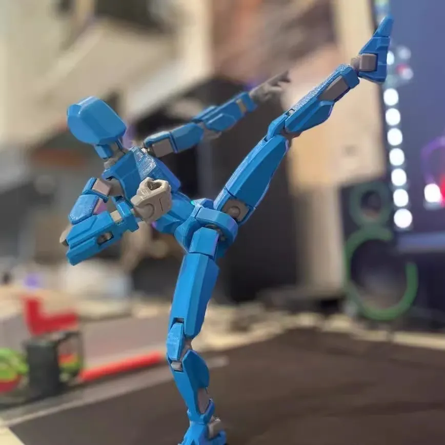 Unassembled 3D printed robot model kit with multi-jointed parts on a table