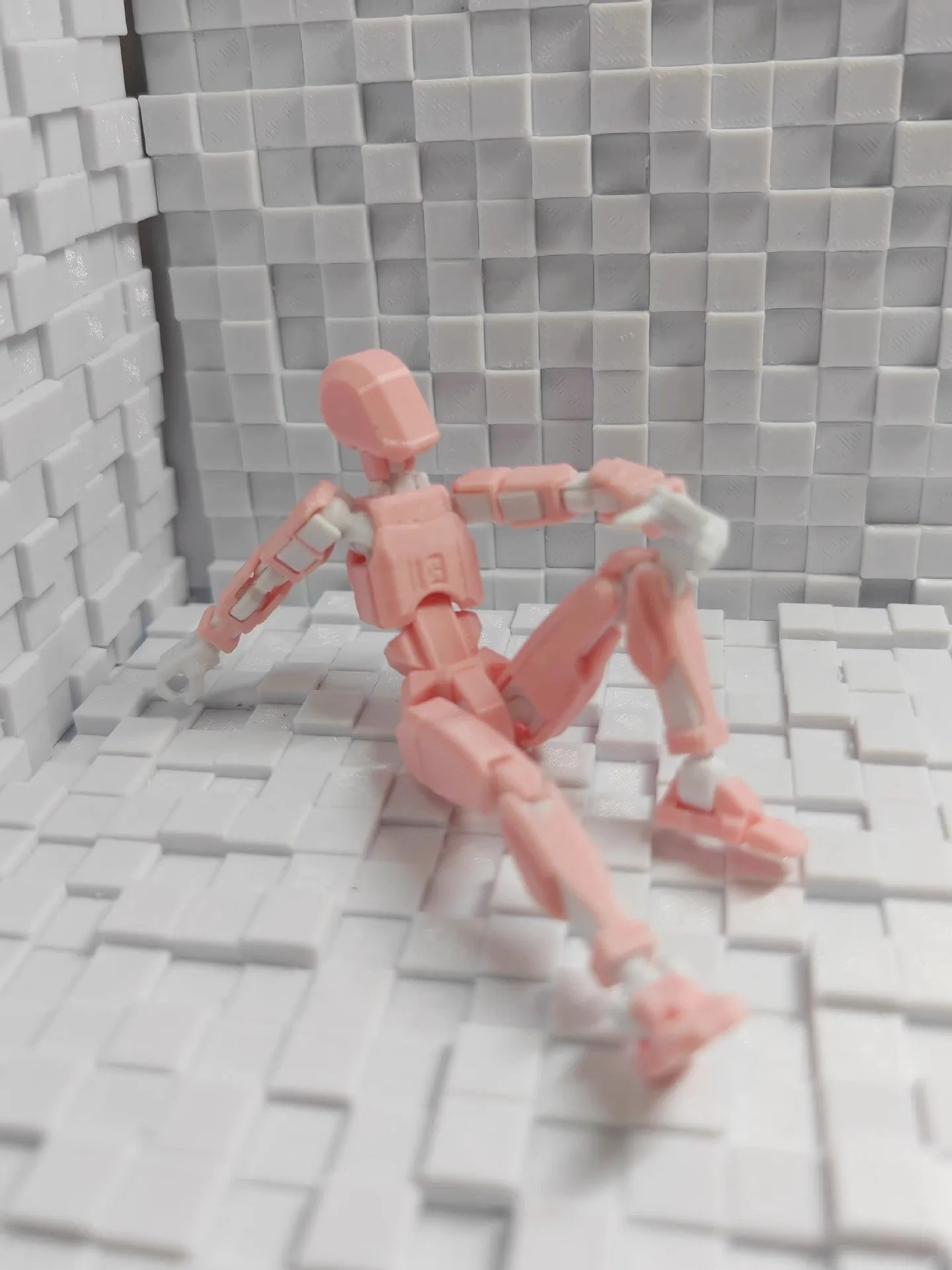 Unassembled 3D printed robot model kit with multi-jointed parts on a table