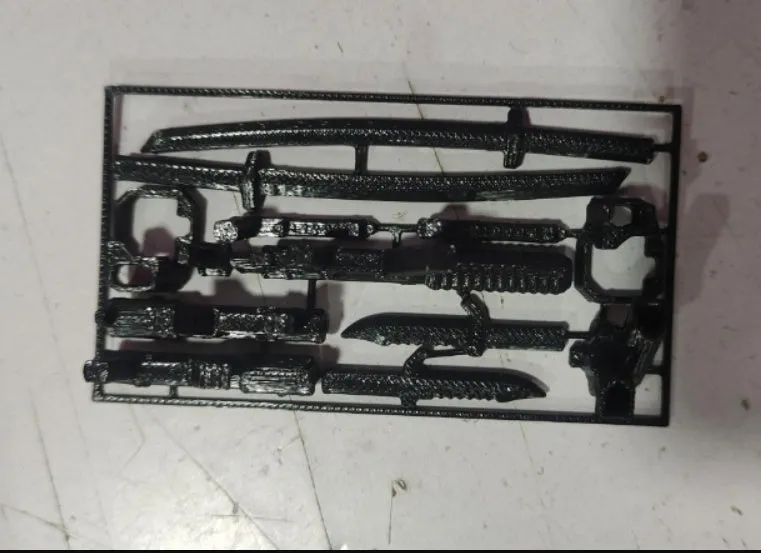 Unassembled 3D printed robot model kit with multi-jointed parts on a table