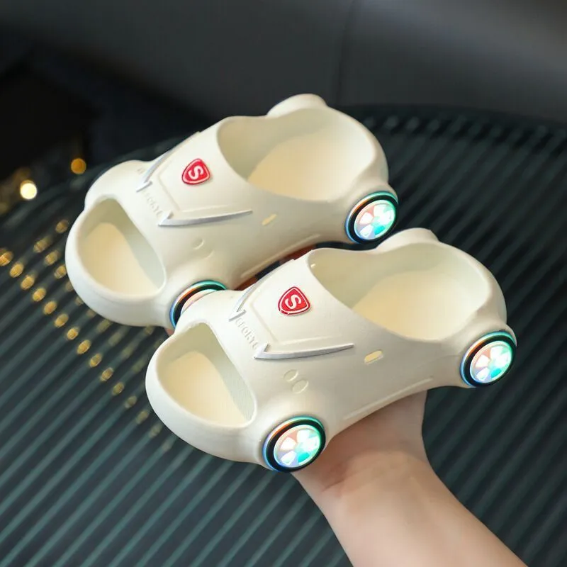 Children's luminous cartoon car design sandals with anti-slip soles on a blue background.