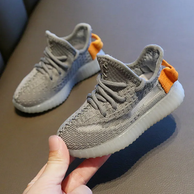 Children's breathable mesh sneakers with non-slip rubber soles in black, white, grey, and orange colours