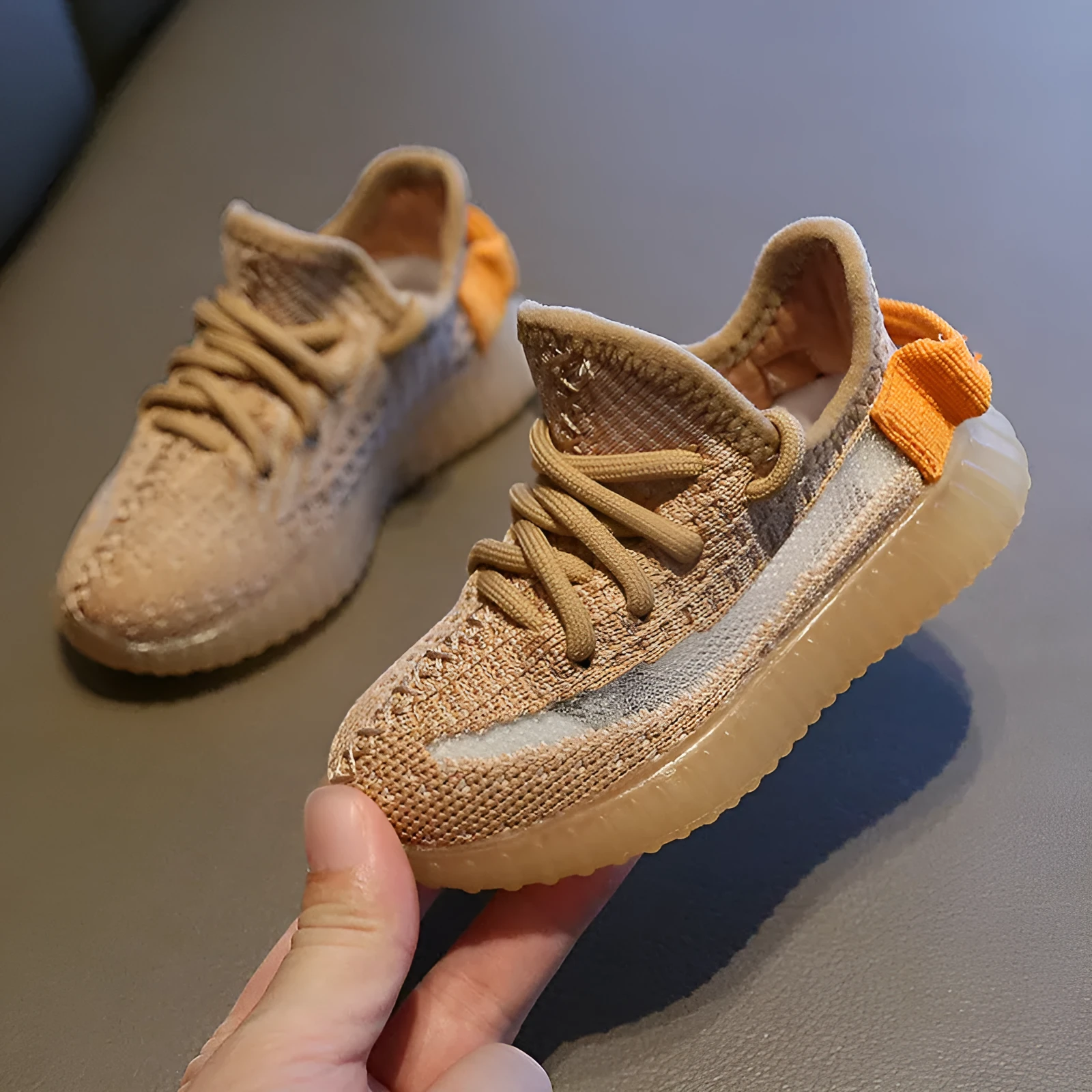 Children's breathable mesh sneakers with non-slip rubber soles in black, white, grey, and orange colours