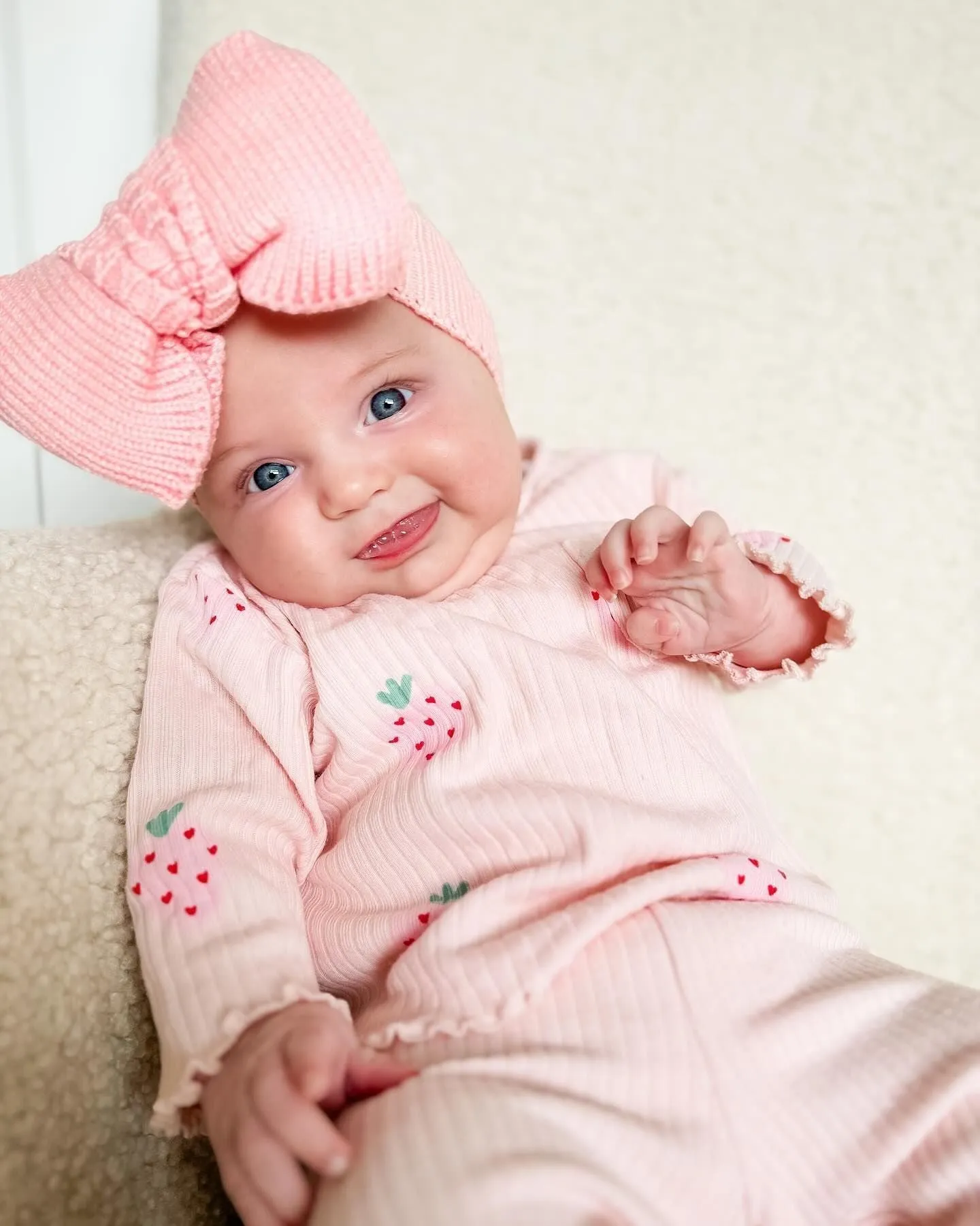 Infant wearing a printed long-sleeve top, solid trousers, and matching cap from the 3-piece suit set.
