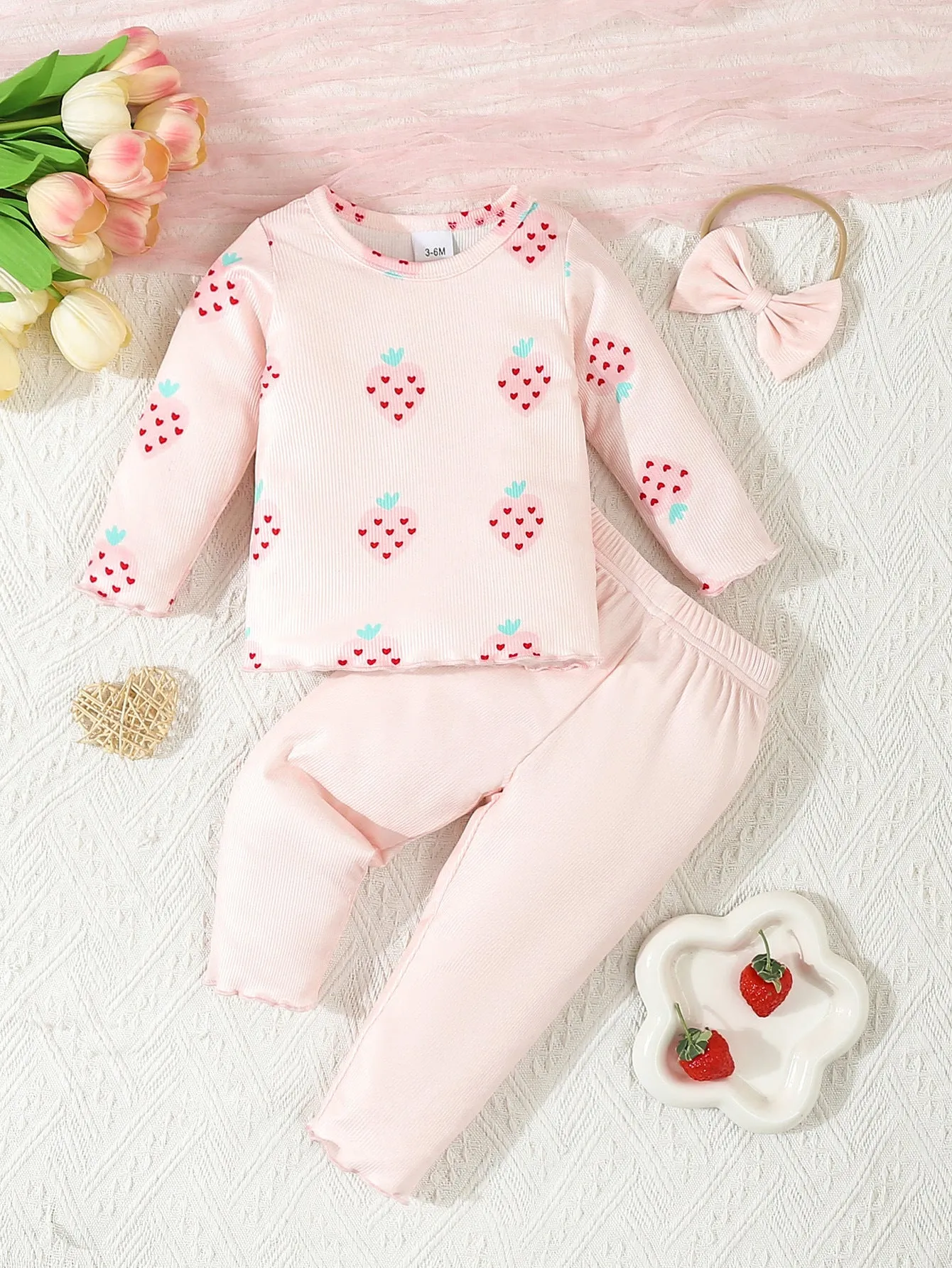Infant wearing a printed long-sleeve top, solid trousers, and matching cap from the 3-piece suit set.