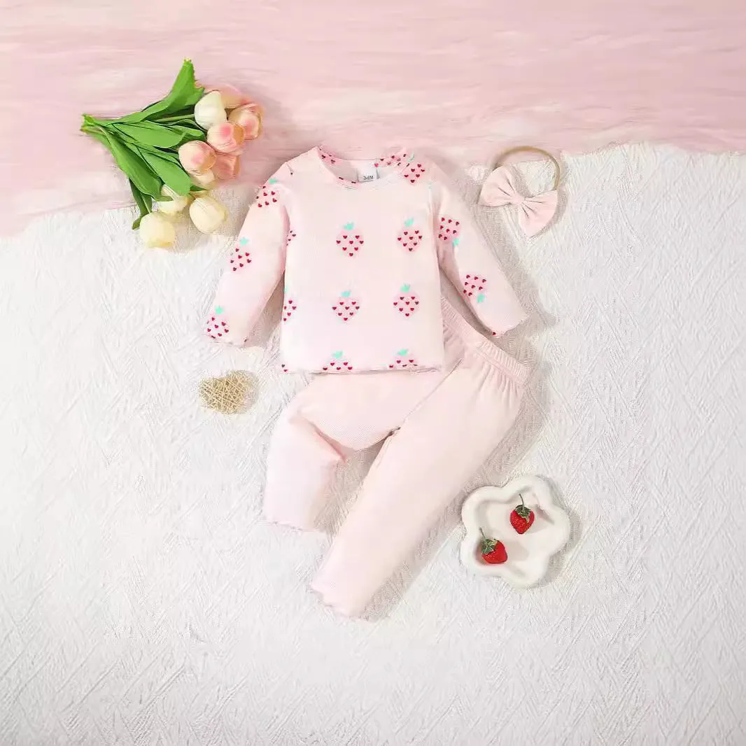 Infant wearing a printed long-sleeve top, solid trousers, and matching cap from the 3-piece suit set.