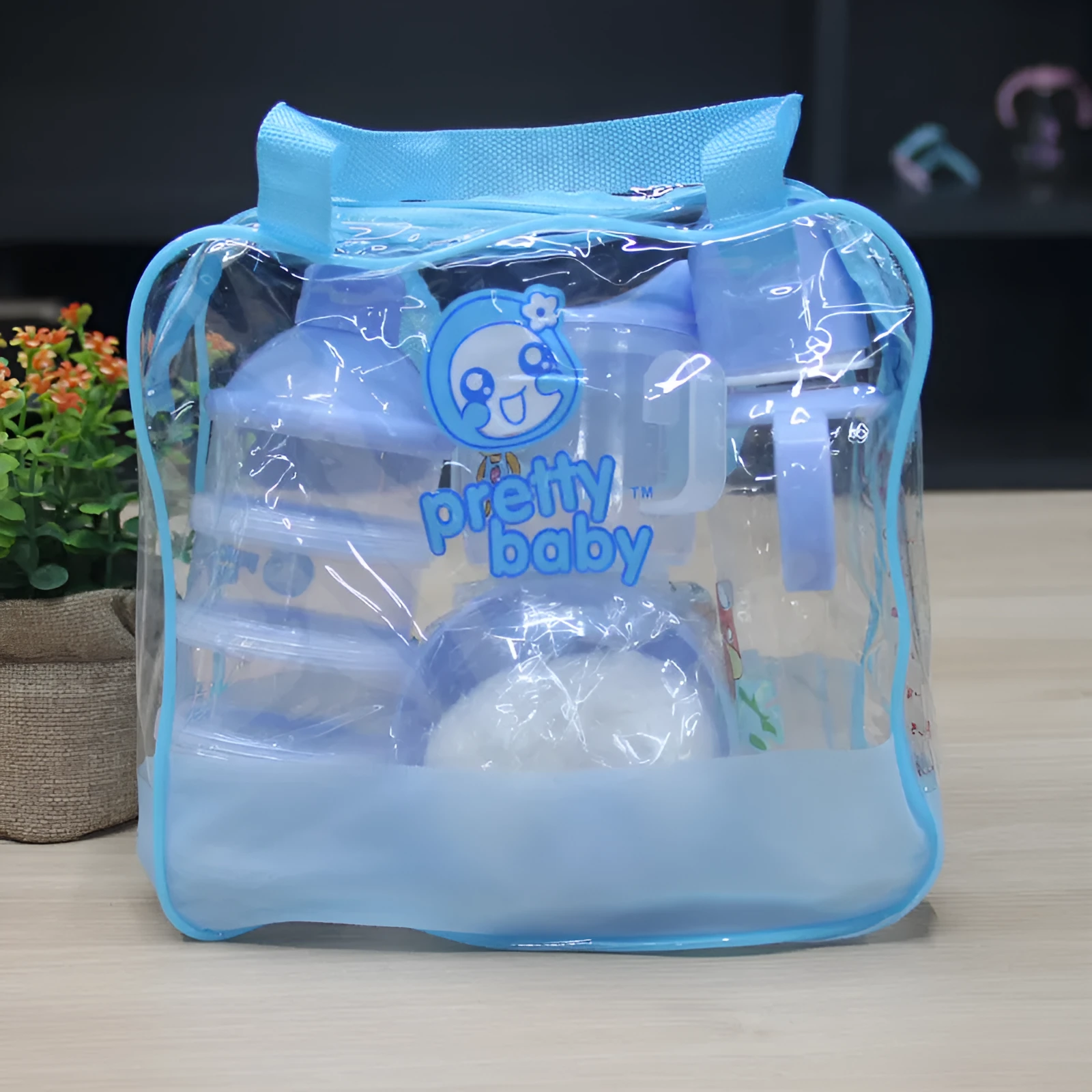 Blue and pink cartoon style plastic baby feeding set with bottle, bowl, bubble box and suction cup.