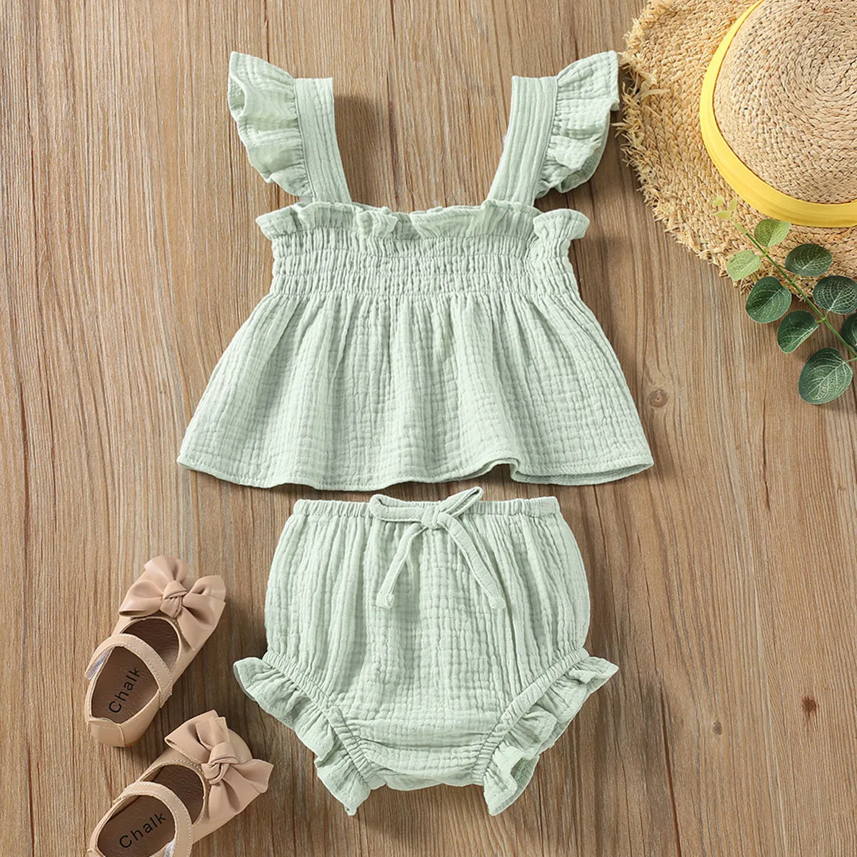 Girls' green cotton two-piece set with sleeveless top and short hot pants.