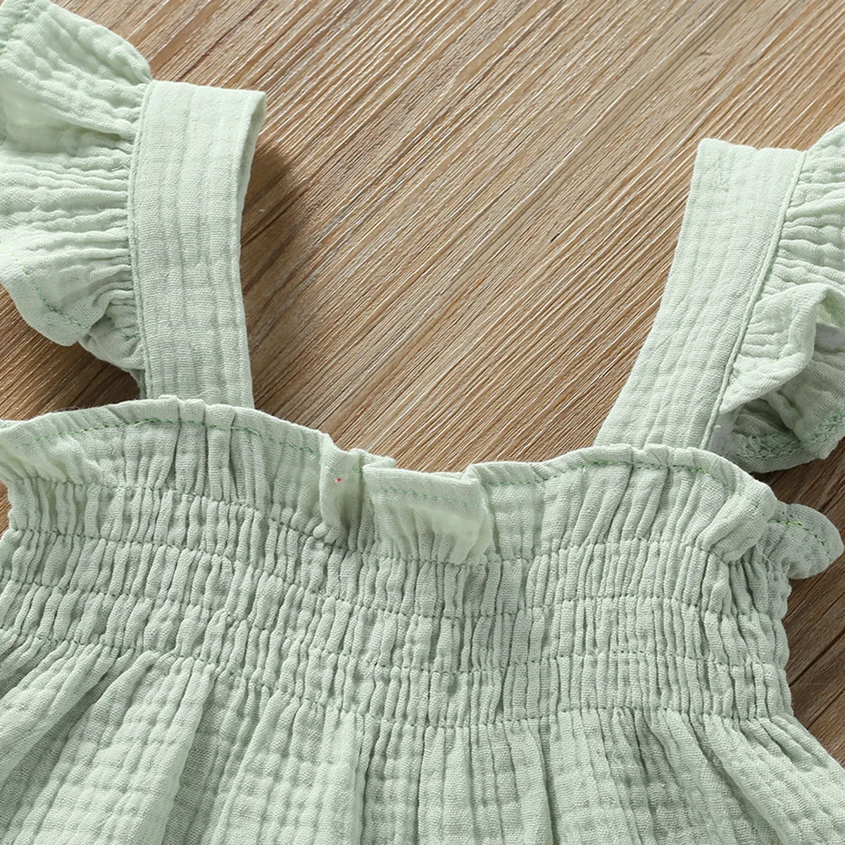 Girls' green cotton two-piece set with sleeveless top and short hot pants.