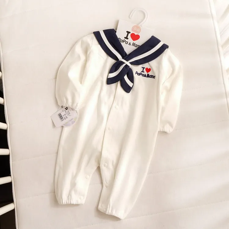 Navy blue Japanese style baby bodysuit with long sleeves and a detachable hood laid flat.