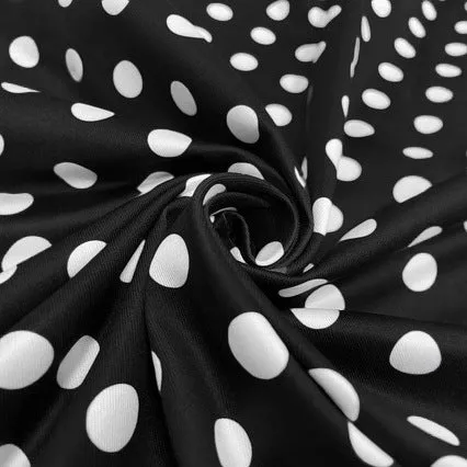 Multicolour polka dot pleated dress with square collar and short sleeves on a hanger.