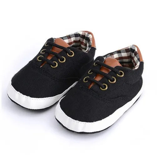 Solid colour baby canvas shoes with a front strap, shown in light grey on a white background.