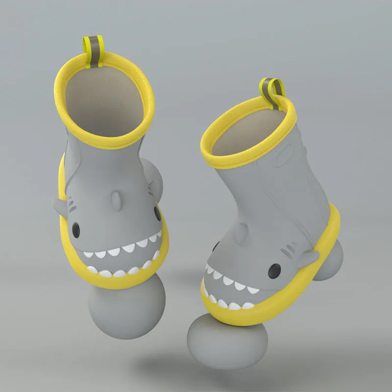 Shark and dinosaur design children's rain boots in green, available in multiple colours and sizes.