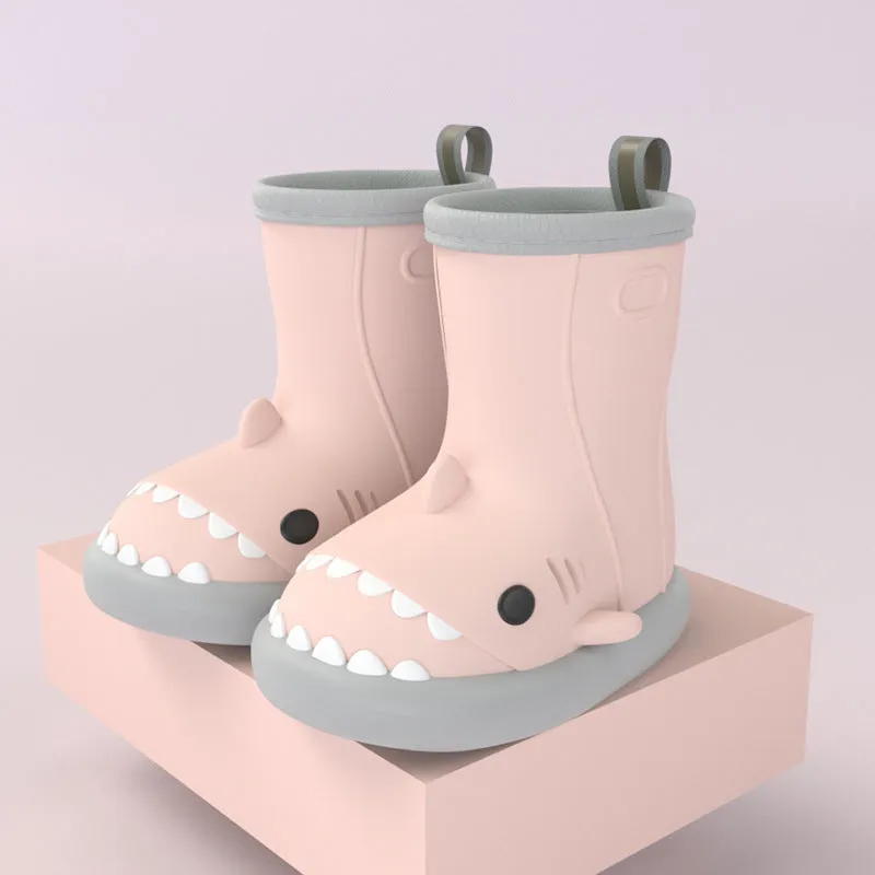 Shark and dinosaur design children's rain boots in green, available in multiple colours and sizes.