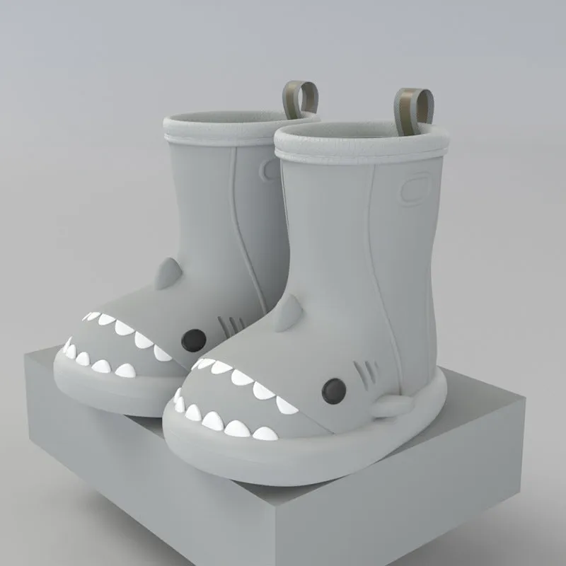 Shark and dinosaur design children's rain boots in green, available in multiple colours and sizes.